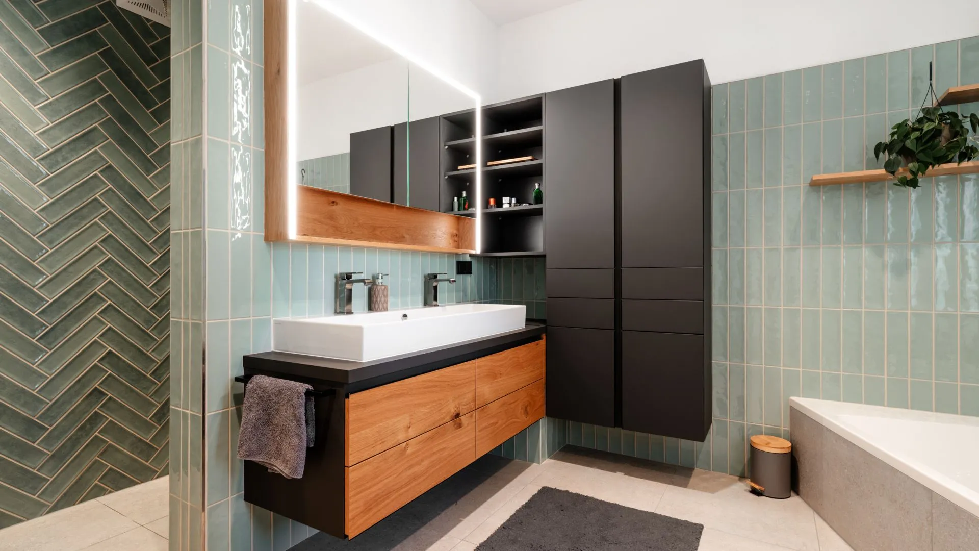 Badezimmer mit grünen Fliesen, Waschtisch und Badewanne