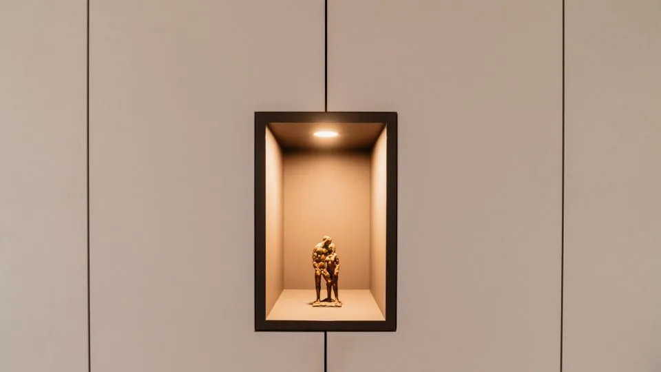 Beleuchtete Wandnische mit kleiner Figur
