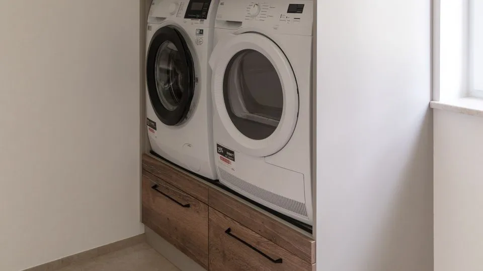 Hauswirtschaftsraum mit Waschmaschine und Trockner in einer Schranknische
